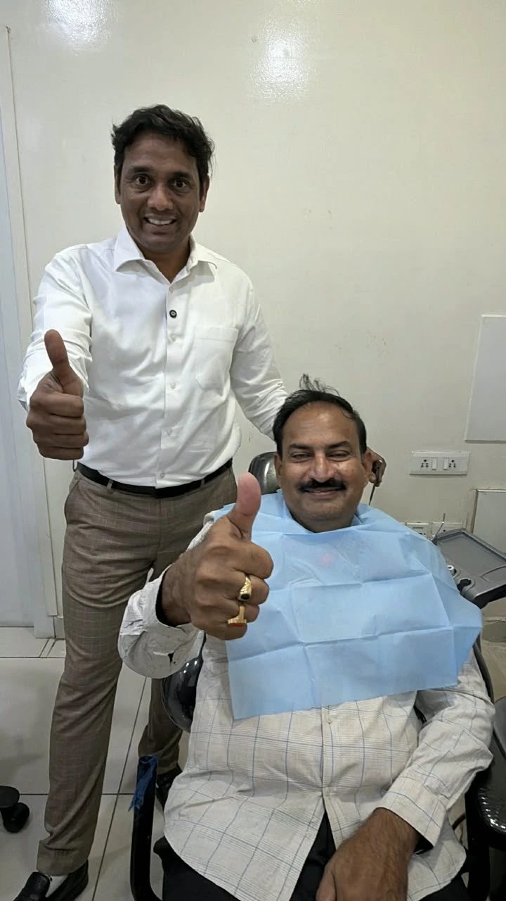 Thumbs up from a happy implant patient